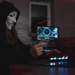 woman in black hoodie holding a bank card